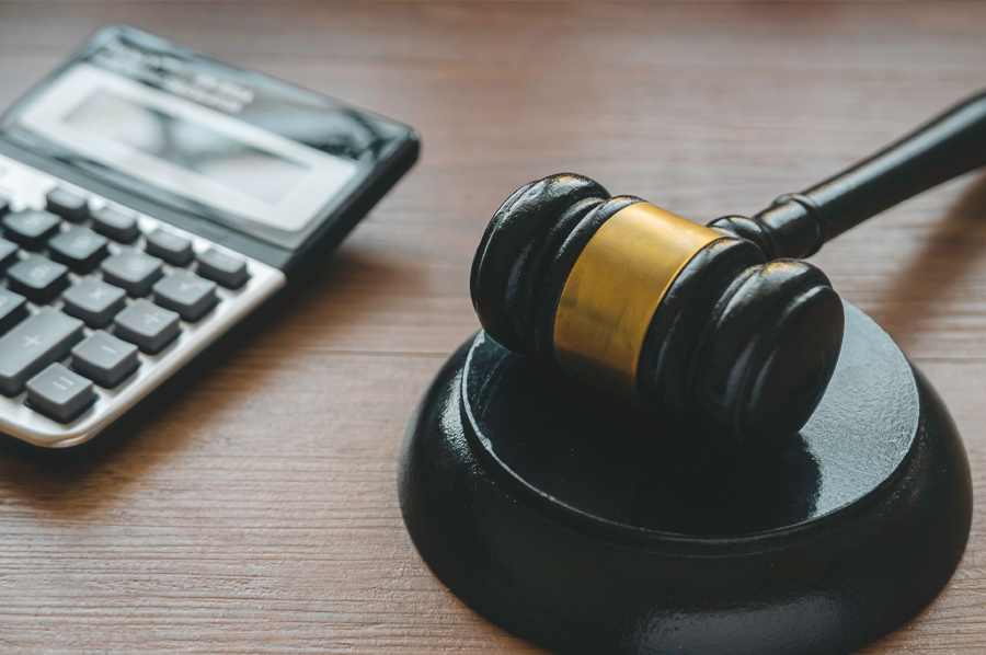 Calculator and gavel representing misdemeanor bail bond calculations