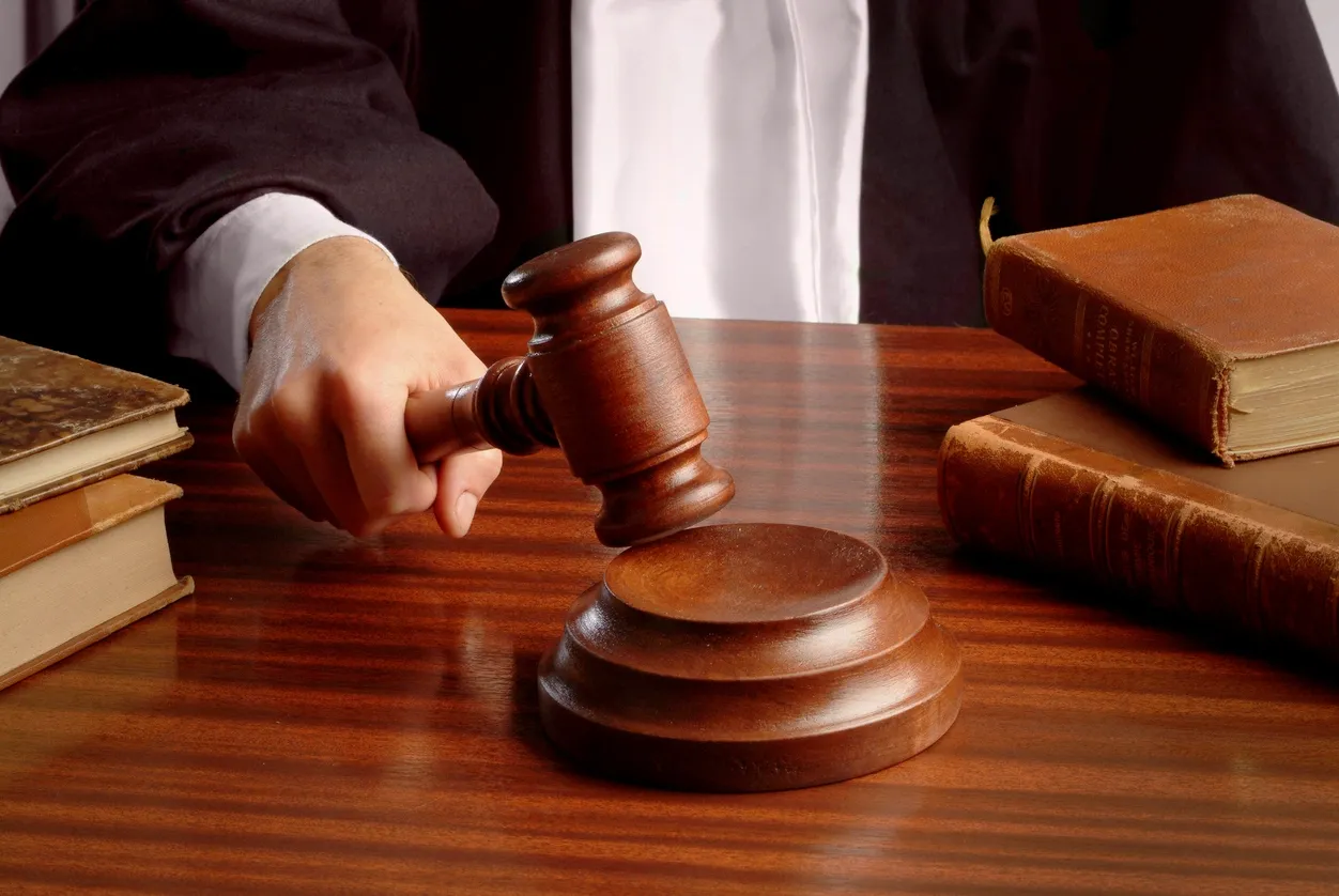 Judge reviewing a probation violation case — Bust Out Bail Bonds can help
