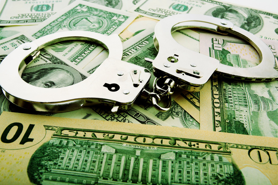 Handcuffs and money representing burglary robbery and theft bail bonds in Louisiana