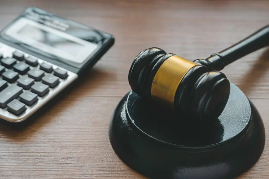 Calculator and gavel representing misdemeanor bail bond calculations